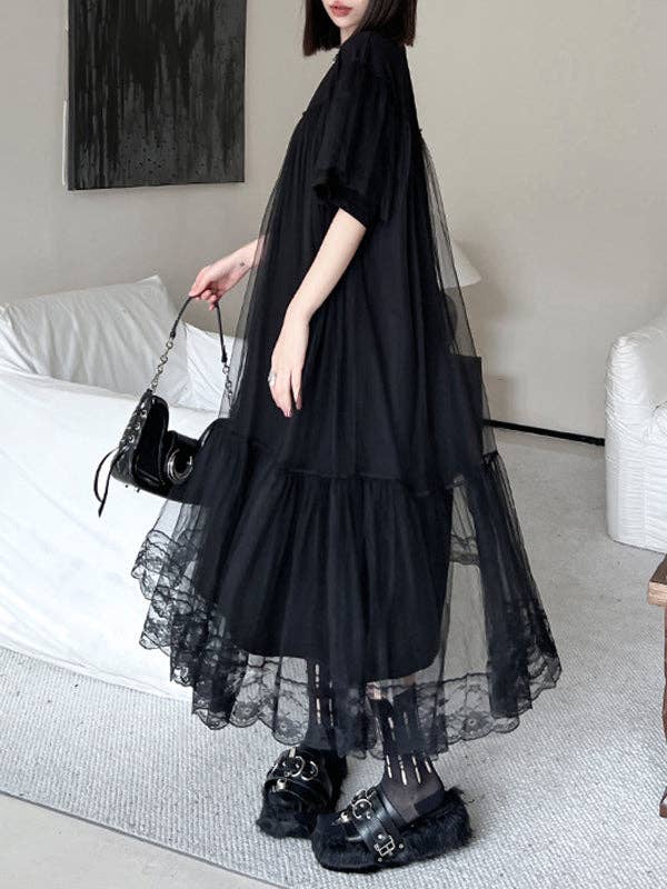 Side view of a black gauzy A-line dress with an edgy design, featuring a flowy silhouette and lightweight fabric, perfect for making a bold statement with a touch of elegance.