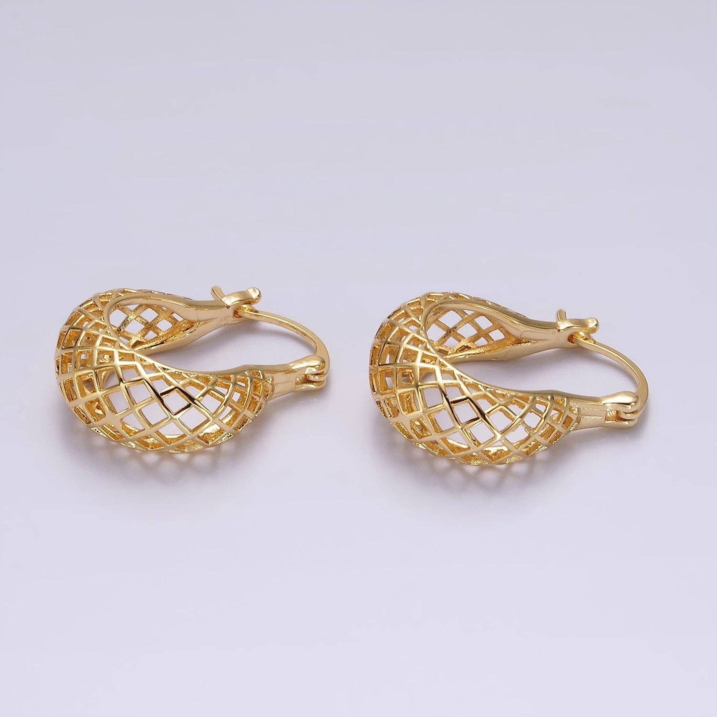 Close-up view of a pair of gold mesh teardrop earrings