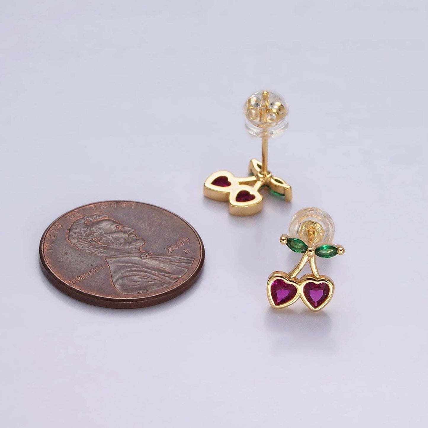 Fuschsia CZ Heart Cherry Earrings with penny for size comparison