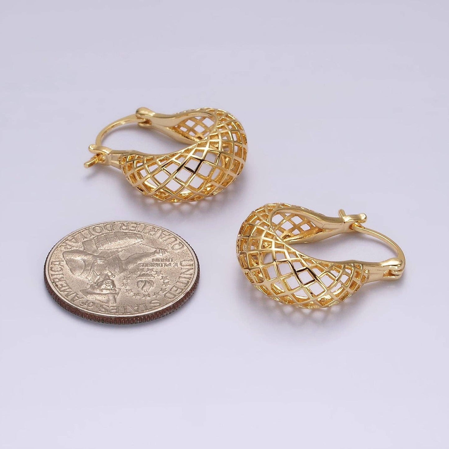 Gold mesh teardrop earrings next to a coin for size comparison