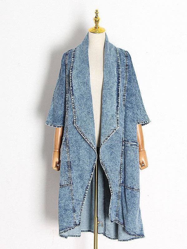 Oversized denim jacket with 3/4 sleeves and large pockets, offering a relaxed fit and stylishly casual vibe.
