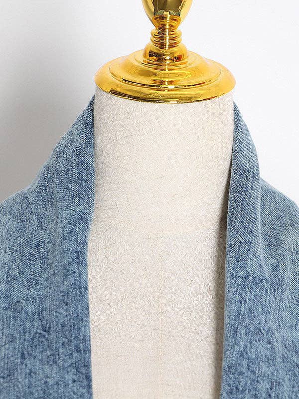 Closeup of oversized denim jacket collar.