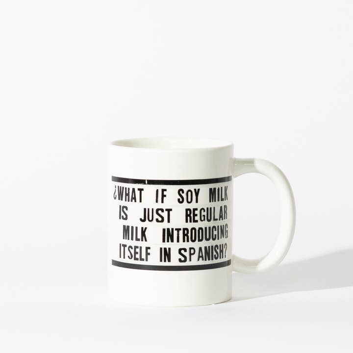A ceramic mug with the text "Soy Milk" in a simple, modern font. The mug is white with a clean design, perfect for enjoying plant-based beverages. Shown on a simple white background.