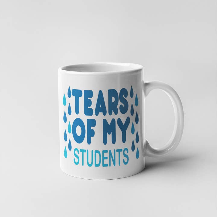 White mug with the phrase "Tears of My Students" alongside playful tear graphics with white handle.