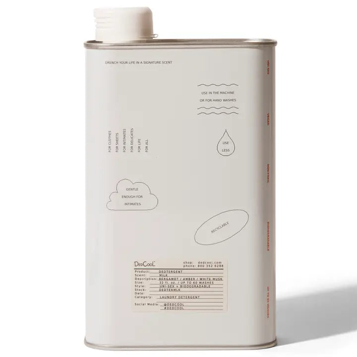 Bottle of milk detergent with a refreshing scent of bergamot, amber, and white musk, placed against a neutral background.