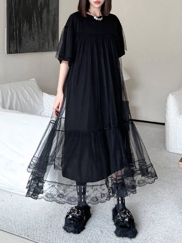 Black gauzy A-line dress with an edgy design, featuring a flowy silhouette and lightweight fabric, perfect for making a bold statement with a touch of elegance.