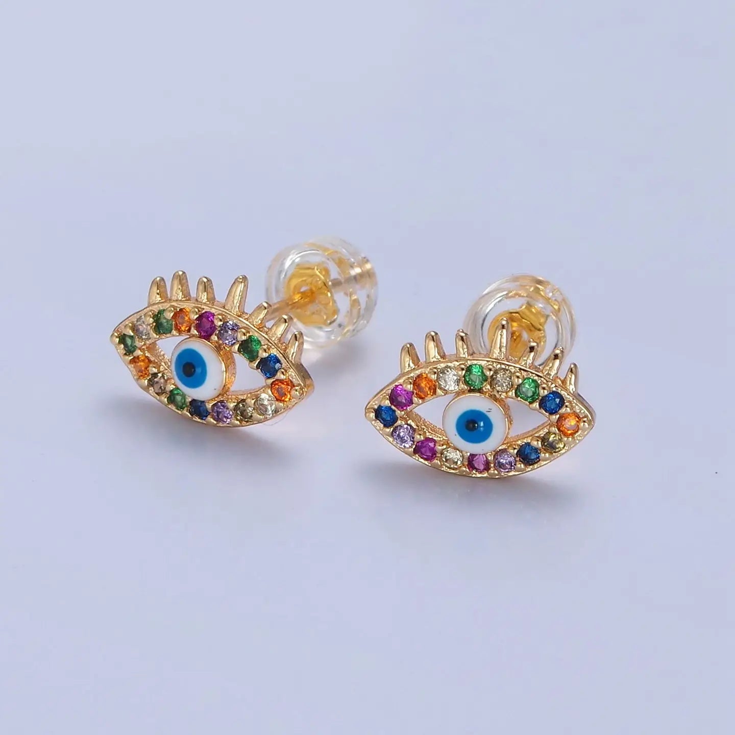 Multi color evil eye earrings on plain background