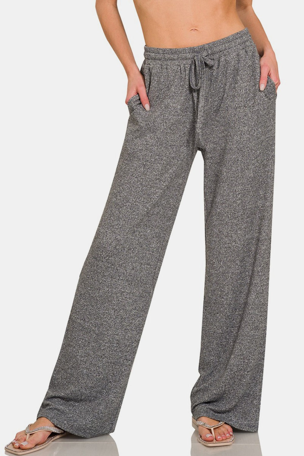 Closeup, front view of drawstring wide-leg pants with side pockets, featuring a comfortable and stylish design, perfect for casual wear or lounging, made from a soft and stretchy fabric blend.
