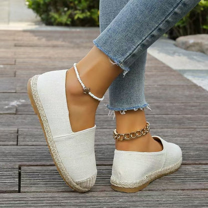 Back and side view of round Toe Flat Slip-Ons in white, showcasing a clean and simple design perfect for casual outfits.