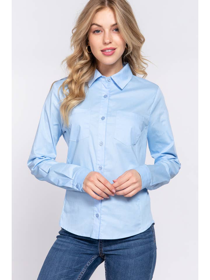 Closeup front view of a woman wearing a light blue button-down shirt with 3/4 roll-up sleeves and skinny jeans, showcasing a casual yet polished look perfect for both work and casual settings. 