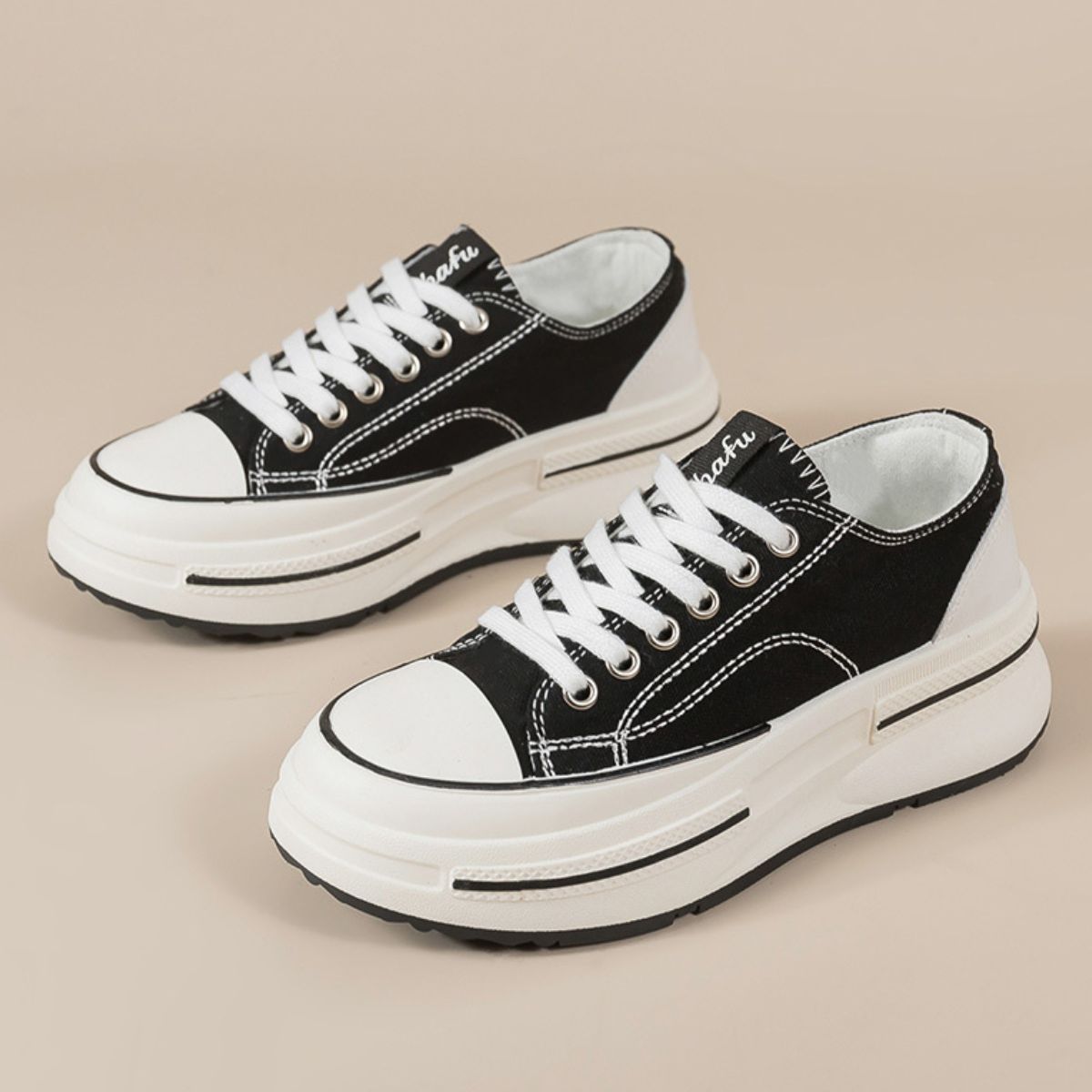 Black Tied Round Toe Platform Sneakers made from elastomer and polyester, offering a trendy and versatile style. These imported sneakers feature a sleek design, perfect for adding a stylish edge to any outfit.