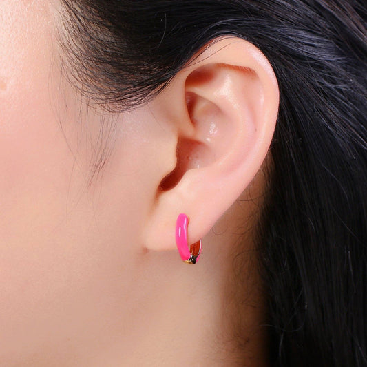 Pair of gold and hot pink enamel hoop earrings.