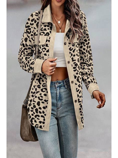 A woman wearing a beige leopard print button-down jacket over a white crop top, paired with light-wash jeans and a crossbody bag. The outfit features a casual, stylish vibe with rolled-up sleeves and simple jewelry, suitable for a versatile and everyday chic look.