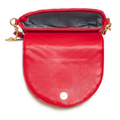 Interior view of a red quilted crossbody bag showing the spacious compartment.