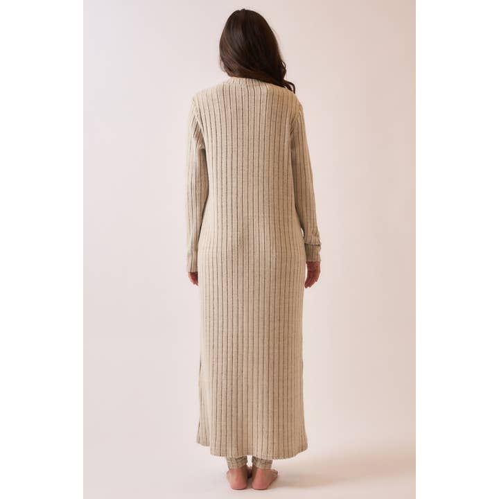 Back view of a soft ribbed long duster cardigan in brushed fabric, styled with matching pieces, featuring a longline silhouette for a cozy and elegant look.