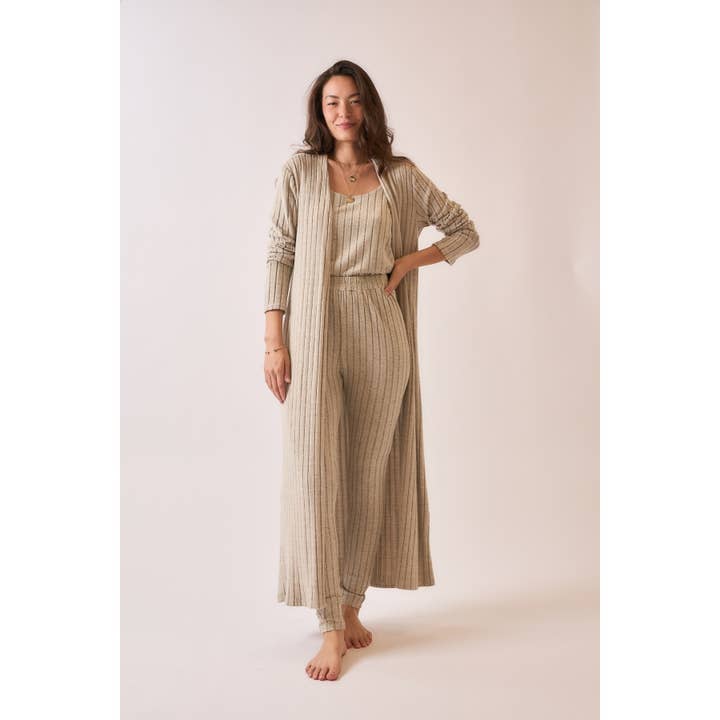 Front view of a soft ribbed long duster cardigan in brushed fabric, styled with matching pieces, featuring a longline silhouette for a cozy and elegant look.