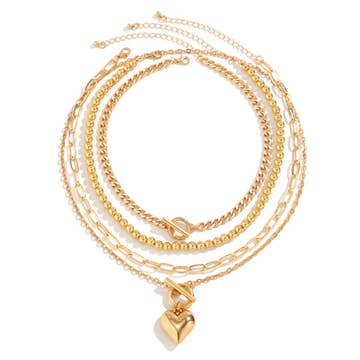 A gold geometric OT buckle heart-shape necklace set laid out flat against a white background.