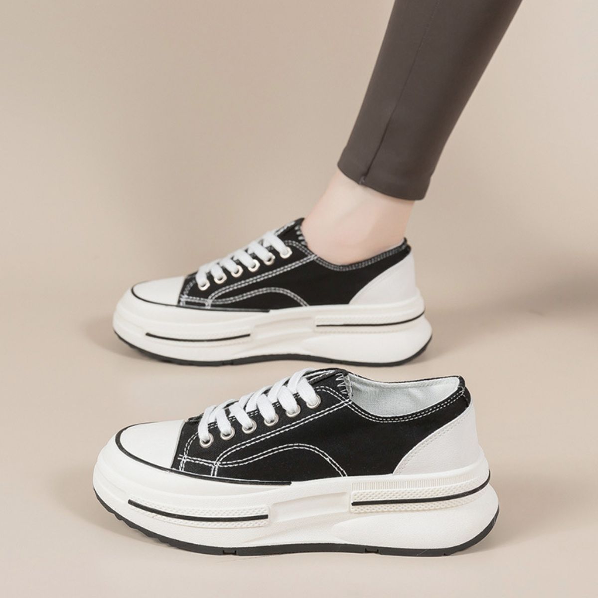 Black Tied Round Toe Platform Sneakers made from elastomer and polyester, offering a trendy and versatile style. These imported sneakers feature a sleek design, perfect for adding a stylish edge to any outfit.